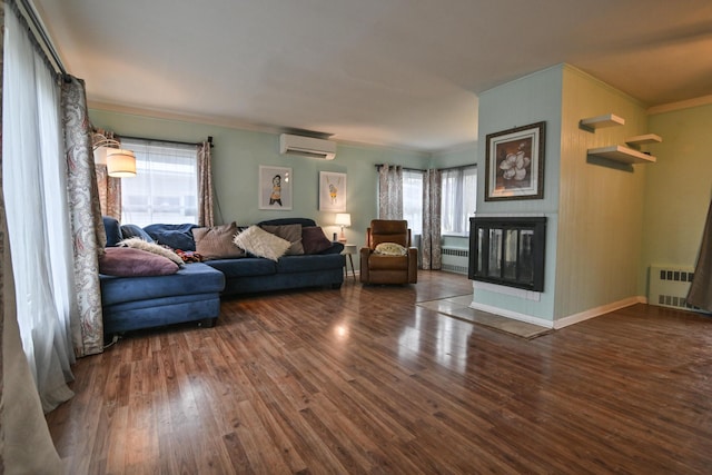 living room featuring radiator heating unit, dark hardwood / wood-style floors, a wall mounted AC, and plenty of natural light