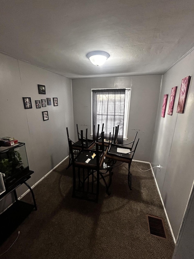 carpeted dining room with baseboards and visible vents