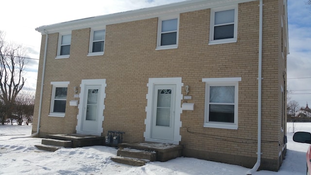 colonial house featuring brick siding