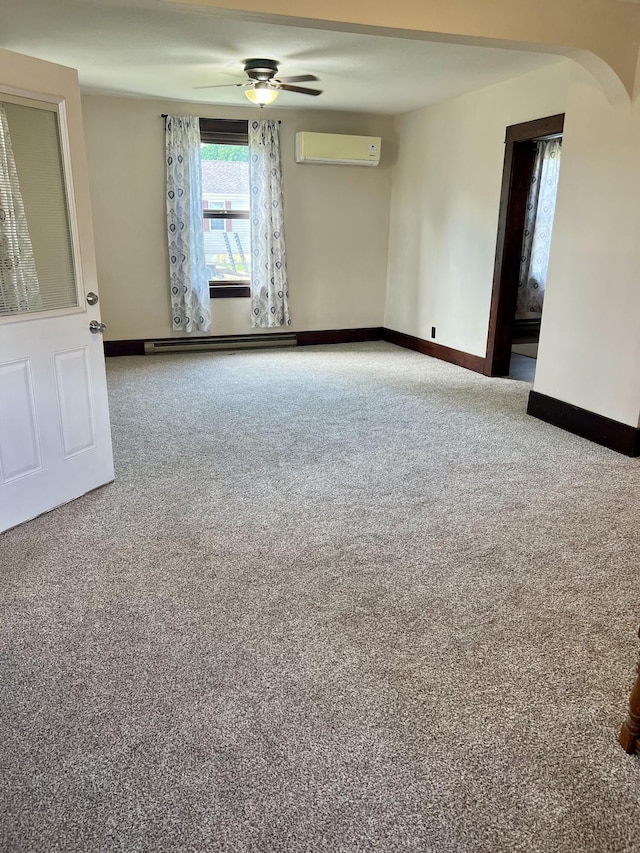 9969 State Route 49, Rockford, OH 45882 - unfurnished room with an AC wall unit, carpet flooring, ceiling fan, a baseboard heating unit, and arched walkways