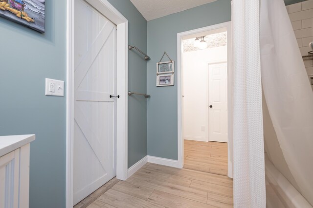 11546 Horseshoe Channel Dr, Lakeview, OH 43331 - hallway with light wood-type flooring and baseboards