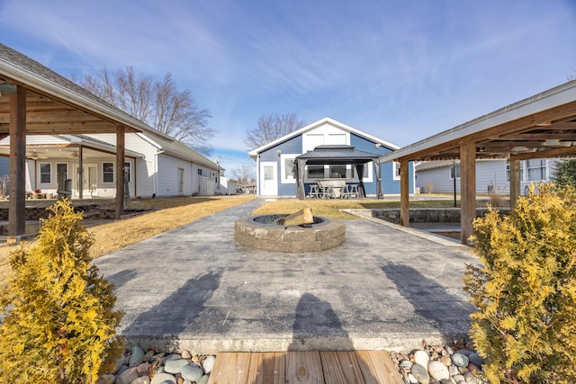 exterior space with a gazebo, a patio, and an outdoor fire pit