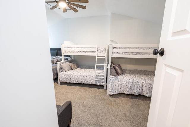 carpeted bedroom with a ceiling fan and vaulted ceiling