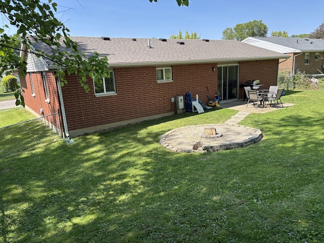 1353 Lee Rd, Troy, OH 45373 - rear view of property with an outdoor fire pit, brick siding, a patio, and a shingled roof