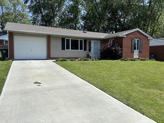 1353 Lee Rd, Troy, OH 45373 - ranch-style home with concrete driveway, a front yard, an attached garage, brick siding, and a shingled roof