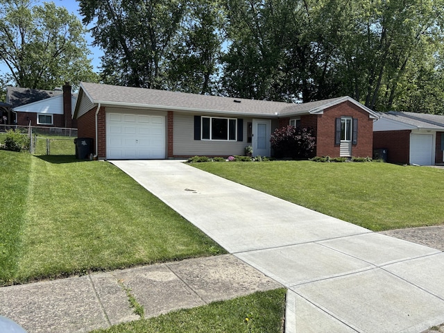 1353 Lee Rd, Troy, OH 45373 - ranch-style house featuring brick siding, driveway, a garage, and roof with shingles