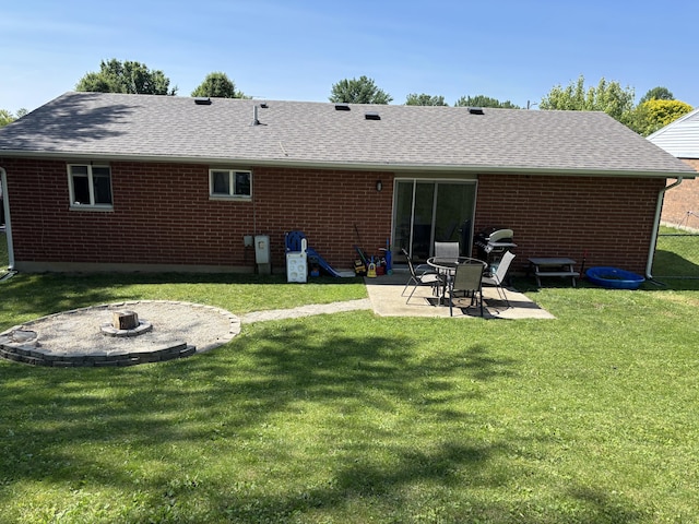 1353 Lee Rd, Troy, OH 45373 - back of house featuring a fire pit, brick siding, a patio, roof with shingles, and a yard
