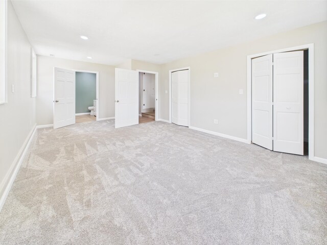 1430 E Union City Pike E, Union City Pike, Winchester, IN 47394 - unfurnished bedroom featuring two closets, carpet flooring, ensuite bathroom, and recessed lighting