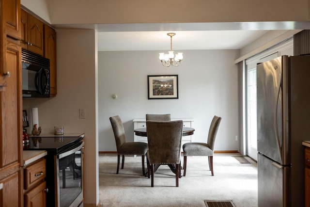 1706 N Fountain Blvd, Springfield, OH 45504 - dining area featuring light colored carpet and a chandelier