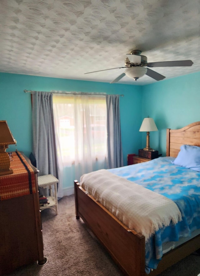 carpeted bedroom with a textured ceiling and ceiling fan