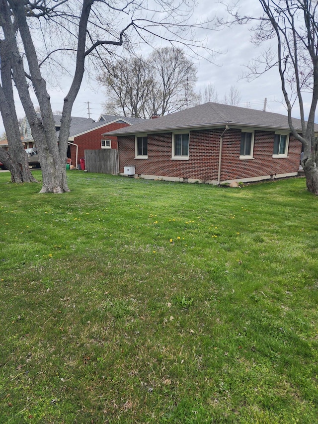 exterior space with a yard and brick siding