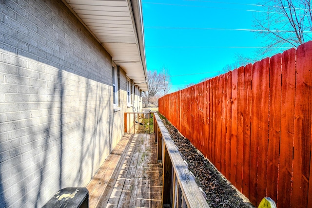 view of home's exterior with brick siding and fence