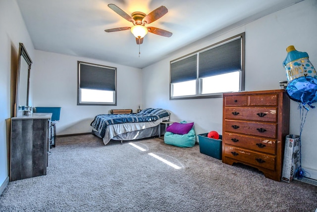 bedroom featuring ceiling fan, multiple windows, and carpet