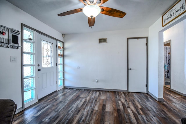 entrance foyer with dark wood-type flooring, visible vents, and baseboards