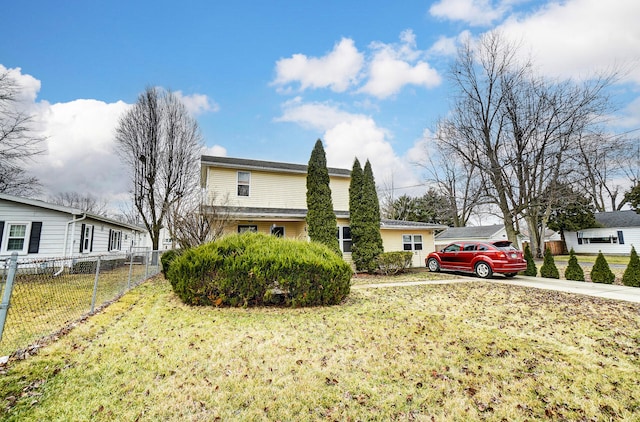 view of home's exterior featuring driveway, a lawn, and fence