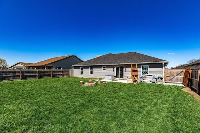 1313 Arrowhead, Piqua, OH 45356 - rear view of property featuring a fenced backyard, a fire pit, and a patio