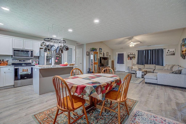 1313 Arrowhead, Piqua, OH 45356 - dining area with light wood-type flooring, a textured ceiling, ceiling fan, recessed lighting, and vaulted ceiling