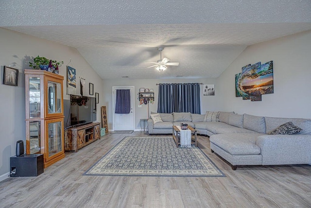 1313 Arrowhead, Piqua, OH 45356 - living room with wood finished floors, a textured ceiling, vaulted ceiling, and a ceiling fan