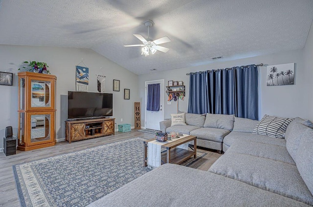 1313 Arrowhead, Piqua, OH 45356 - living area with wood finished floors, ceiling fan, vaulted ceiling, and a textured ceiling