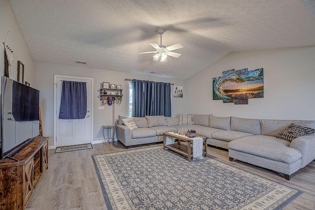 1313 Arrowhead, Piqua, OH 45356 - living room featuring light wood-style floors, a ceiling fan, a textured ceiling, and lofted ceiling