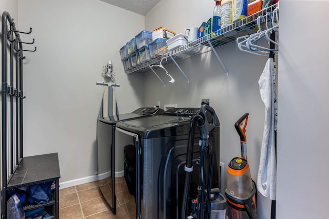 washroom featuring baseboards, laundry area, tile patterned flooring, and washer and dryer