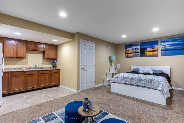 bedroom with recessed lighting, baseboards, a sink, and light colored carpet