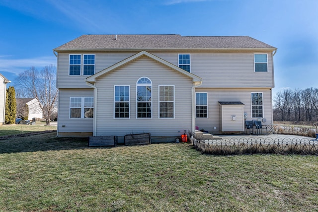 rear view of property featuring a lawn and a patio