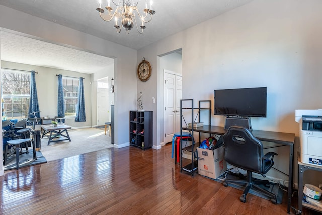 office featuring a chandelier, dark wood-style flooring, a textured ceiling, and baseboards