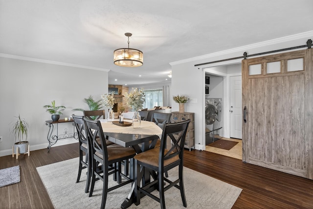 1814 Kingsbury Dr, Saint Marys, OH 45885 - dining room with washing machine and dryer, ornamental molding, a chandelier, wood finished floors, and a barn door