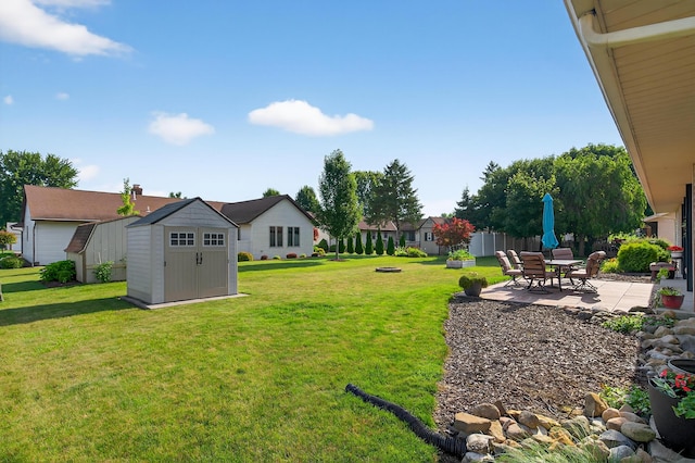 1814 Kingsbury Dr, Saint Marys, OH 45885 - view of grassy yard featuring a storage unit and a patio area