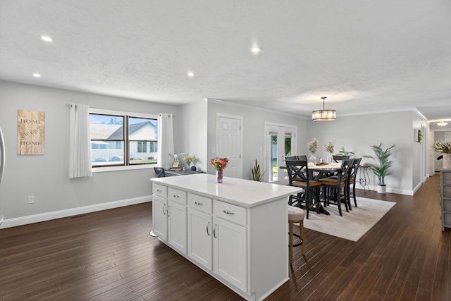 1814 Kingsbury Dr, Saint Marys, OH 45885 - kitchen featuring white cabinetry, a kitchen island, dark wood-style floors, recessed lighting, and light countertops