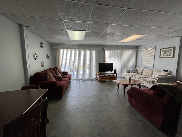 living room with a drop ceiling and wood finished floors