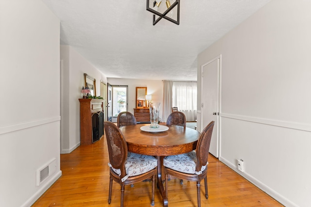 542 Lohnes Dr, Fairborn, OH 45324 - dining space featuring a fireplace and light wood-style flooring
