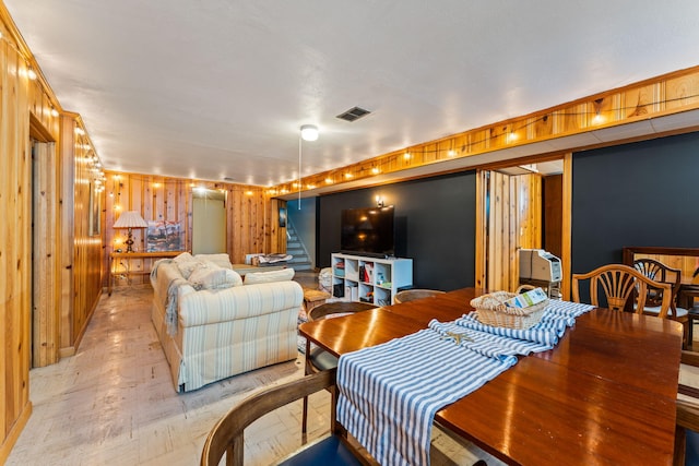 542 Lohnes Dr, Fairborn, OH 45324 - dining area featuring stairway, light wood-style flooring, and wooden walls