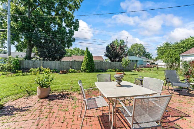 542 Lohnes Dr, Fairborn, OH 45324 - fenced backyard with outdoor dining space and a patio