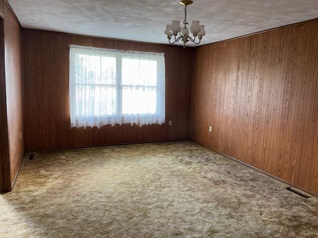 9050 N State Route 49, Greenville, OH 45331 - empty room featuring a chandelier, wood walls, and carpet flooring