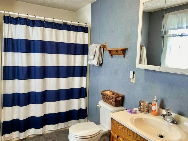 bathroom featuring vanity, toilet, a textured ceiling, and a shower with shower curtain