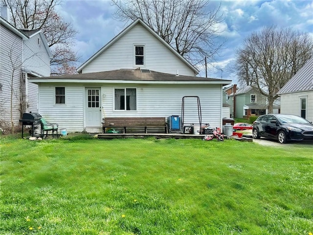 back of property featuring a lawn