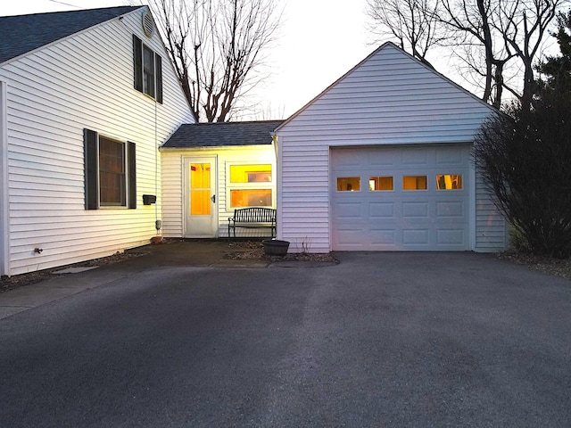 view of front of property featuring aphalt driveway and a shingled roof