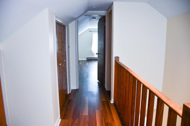 corridor with a baseboard heating unit, lofted ceiling, and dark wood-type flooring