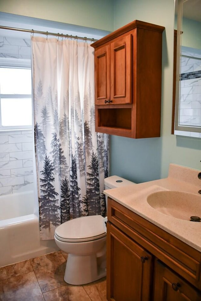 bathroom with vanity, tile patterned flooring, shower / bath combo with shower curtain, and toilet