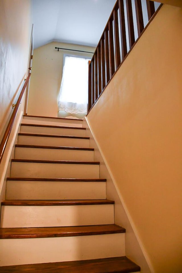 stairway with lofted ceiling