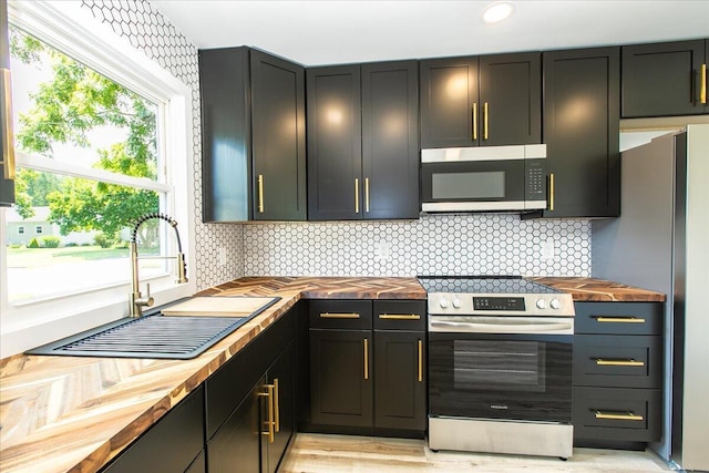 188 S Walnut St, Germantown, OH 45327 - kitchen featuring wooden counters, stainless steel appliances, tasteful backsplash, and recessed lighting