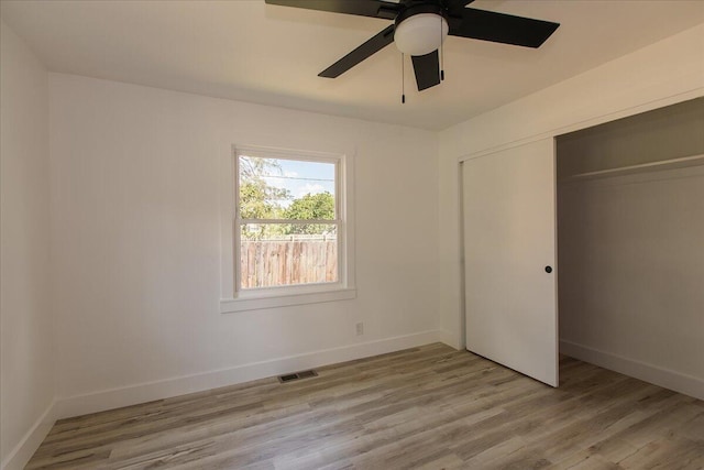 188 S Walnut St, Germantown, OH 45327 - unfurnished bedroom featuring a closet, light wood-style floors, and a ceiling fan