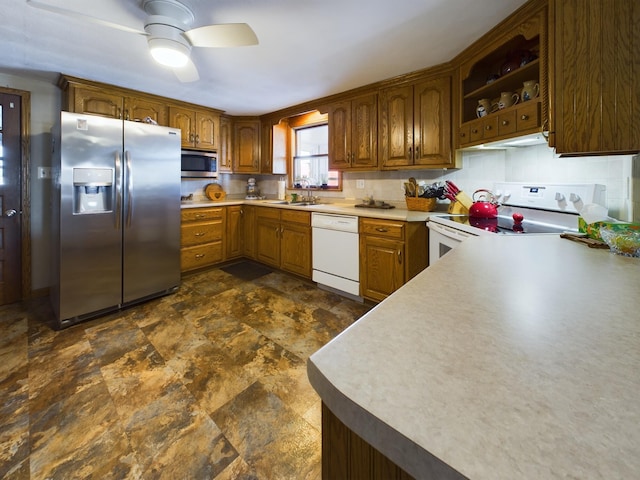 kitchen with sink, decorative backsplash, ceiling fan, and appliances with stainless steel finishes