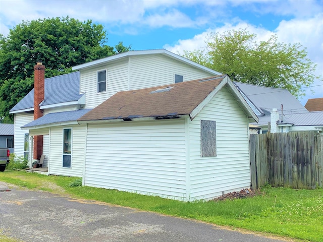 116 N Mill St, De Graff, OH 43318 - view of side of home featuring roof with shingles and a chimney