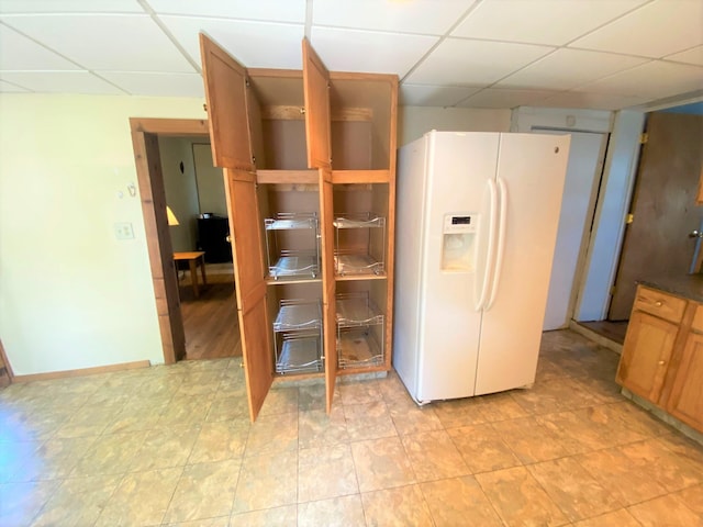 116 N Mill St, De Graff, OH 43318 - kitchen featuring white fridge with ice dispenser, a drop ceiling, and brown cabinets