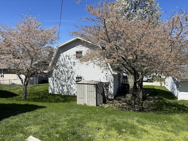 view of outbuilding with fence and an outbuilding