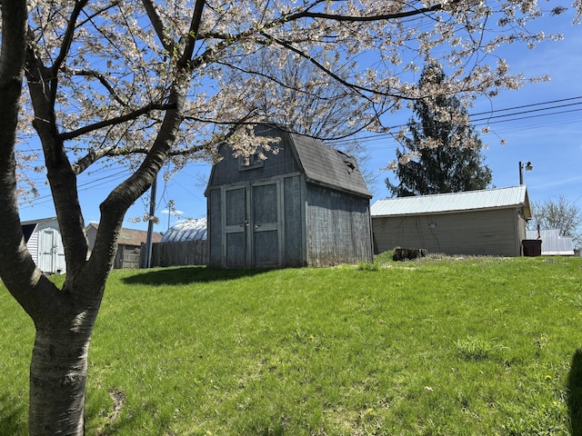 view of yard with an outbuilding and a shed