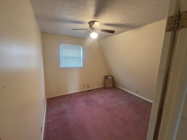 bonus room with a textured ceiling, ceiling fan, baseboards, carpet flooring, and visible vents